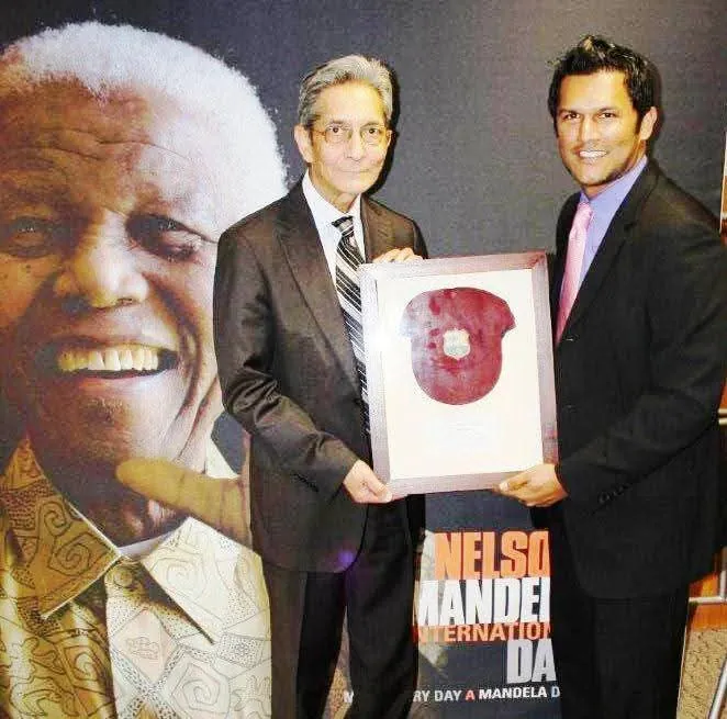 Framed cricket cap presented at a Nelson Mandela International Day event